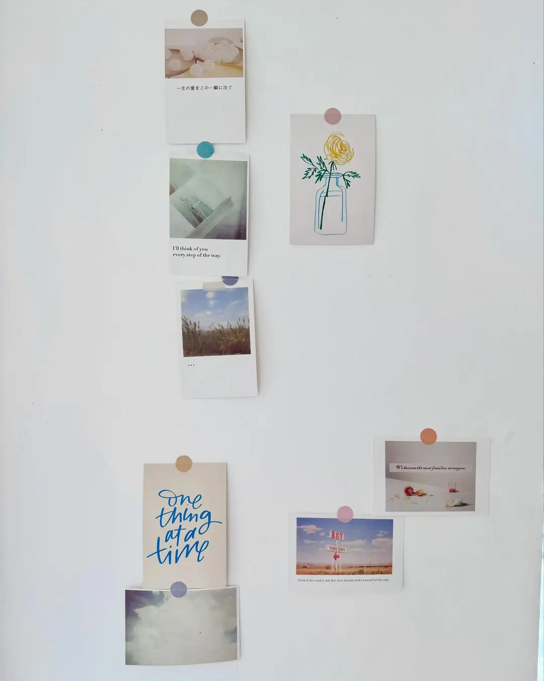 Wall of small photo prints and handwritten notes