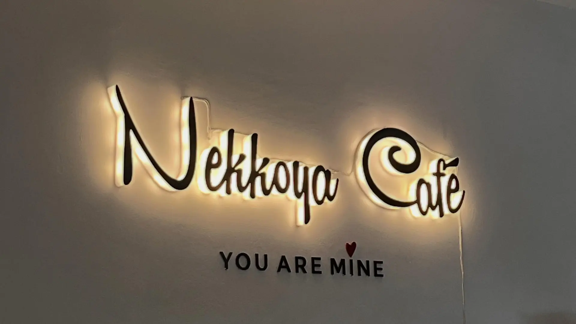 Backlit Nekkoya Café — You Are Mine signage glowing on the 2F wall